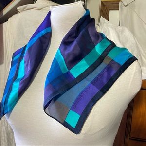 A Vittadini silk scarf; deep vibrant purple, blues, and black, 22” square